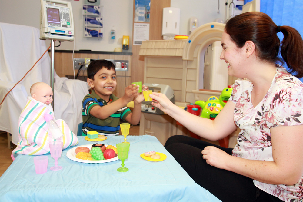WCH Play Therapist Jessica and WCH patient Rushi engage in activities.