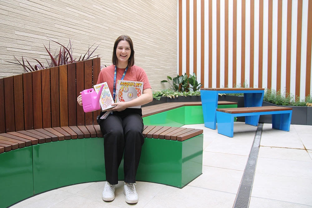 Lauren's Legacy : Play Therapist, Kate, in Mallee Ward’s outdoor area with gardening and art supplies funding through the Lauren Corena Fund. 