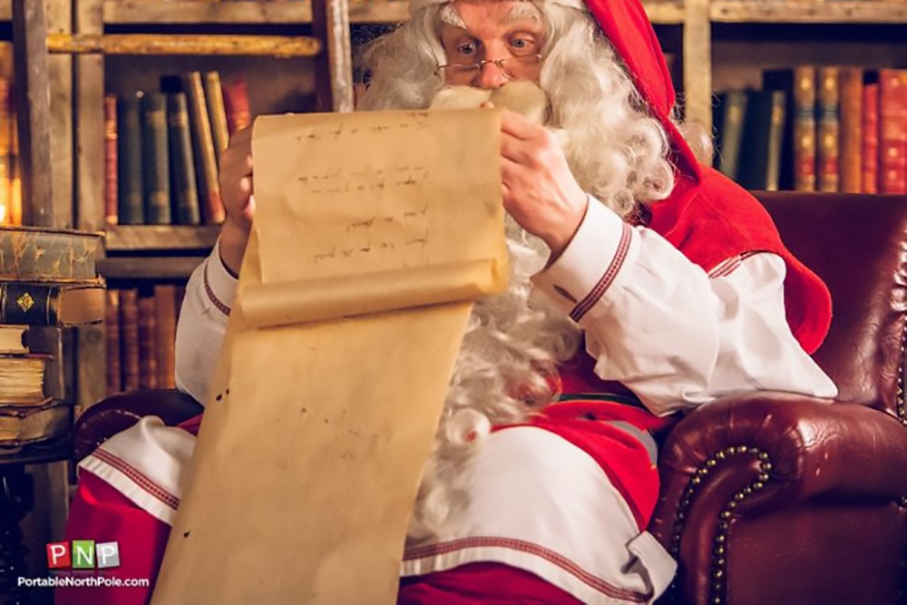 Santa sitting on a chair.