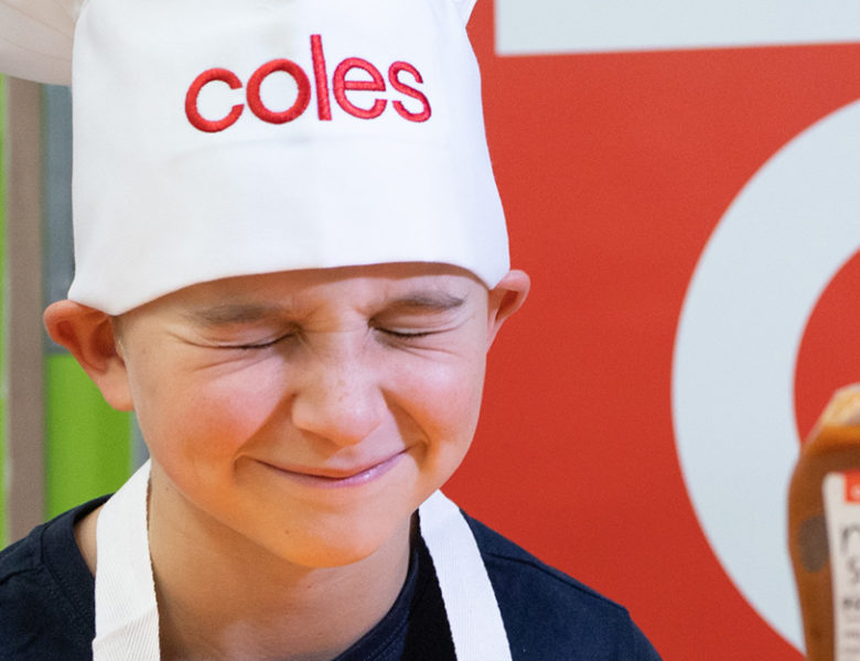 Kai in front of Coles' Mum's Sause Pizza Sauce