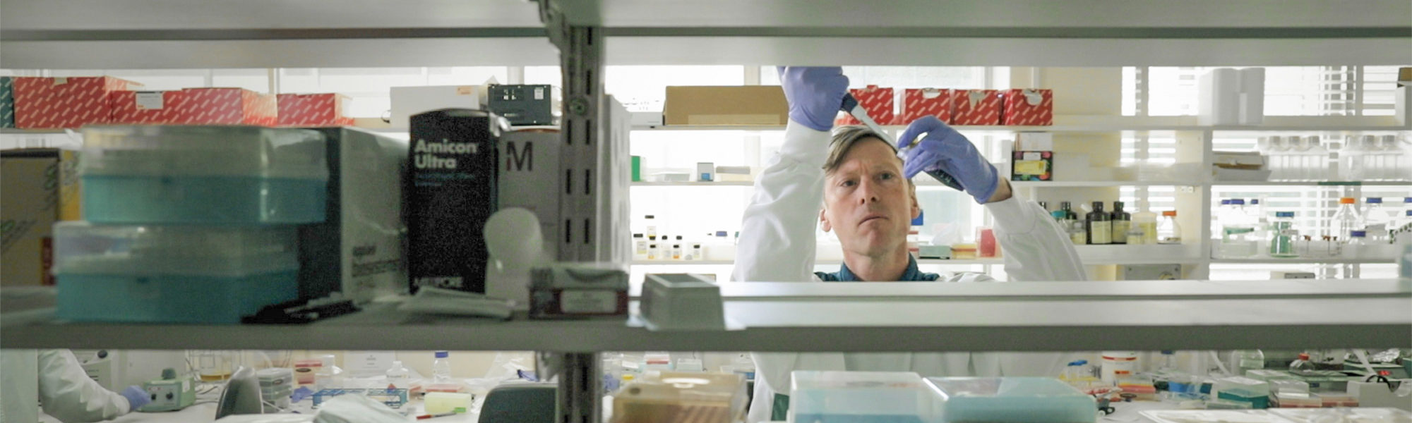 Man in white lab coat in laboratory