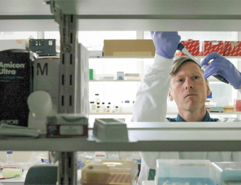 Man in white lab coat in laboratory