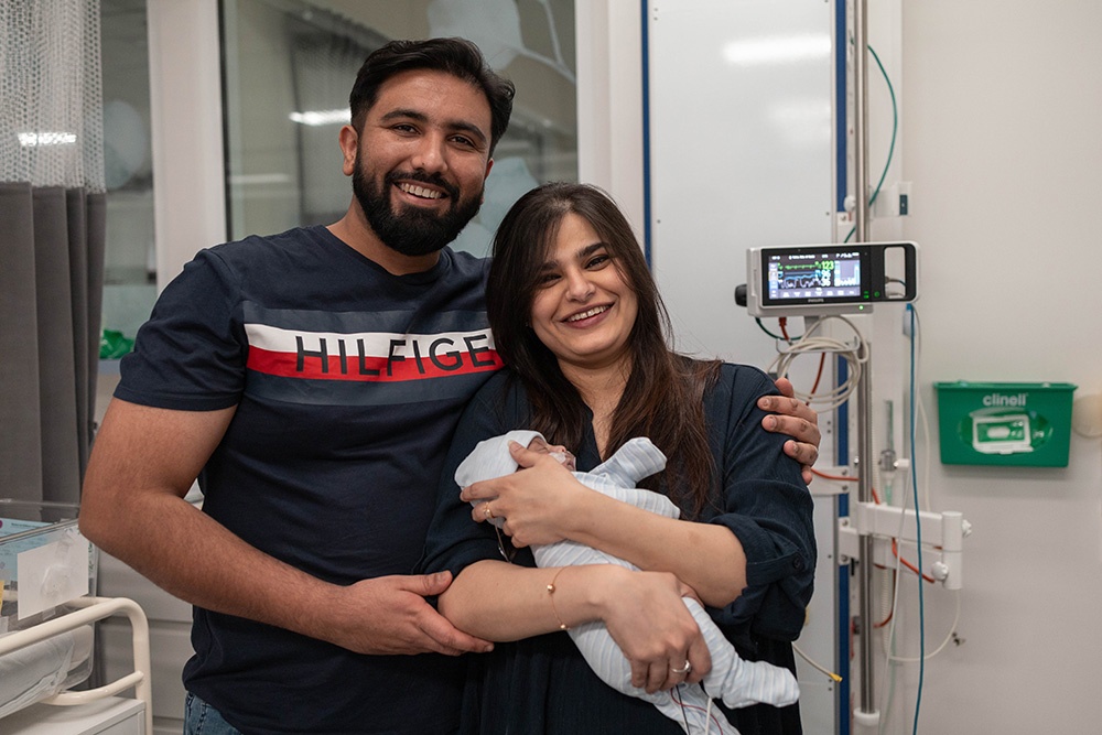 Farhan and Nazish holding their adorable baby, Abdul Ahad