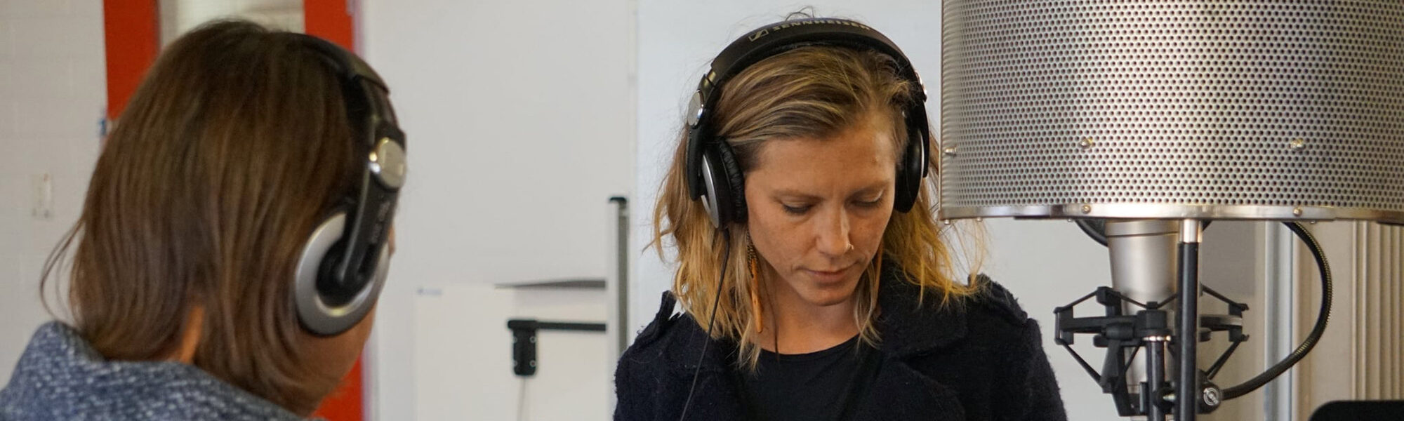 two females with headphones on