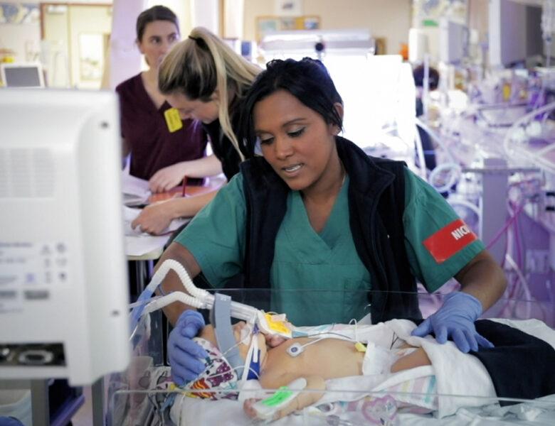 A nurse attending to a baby in the WCH NICU.