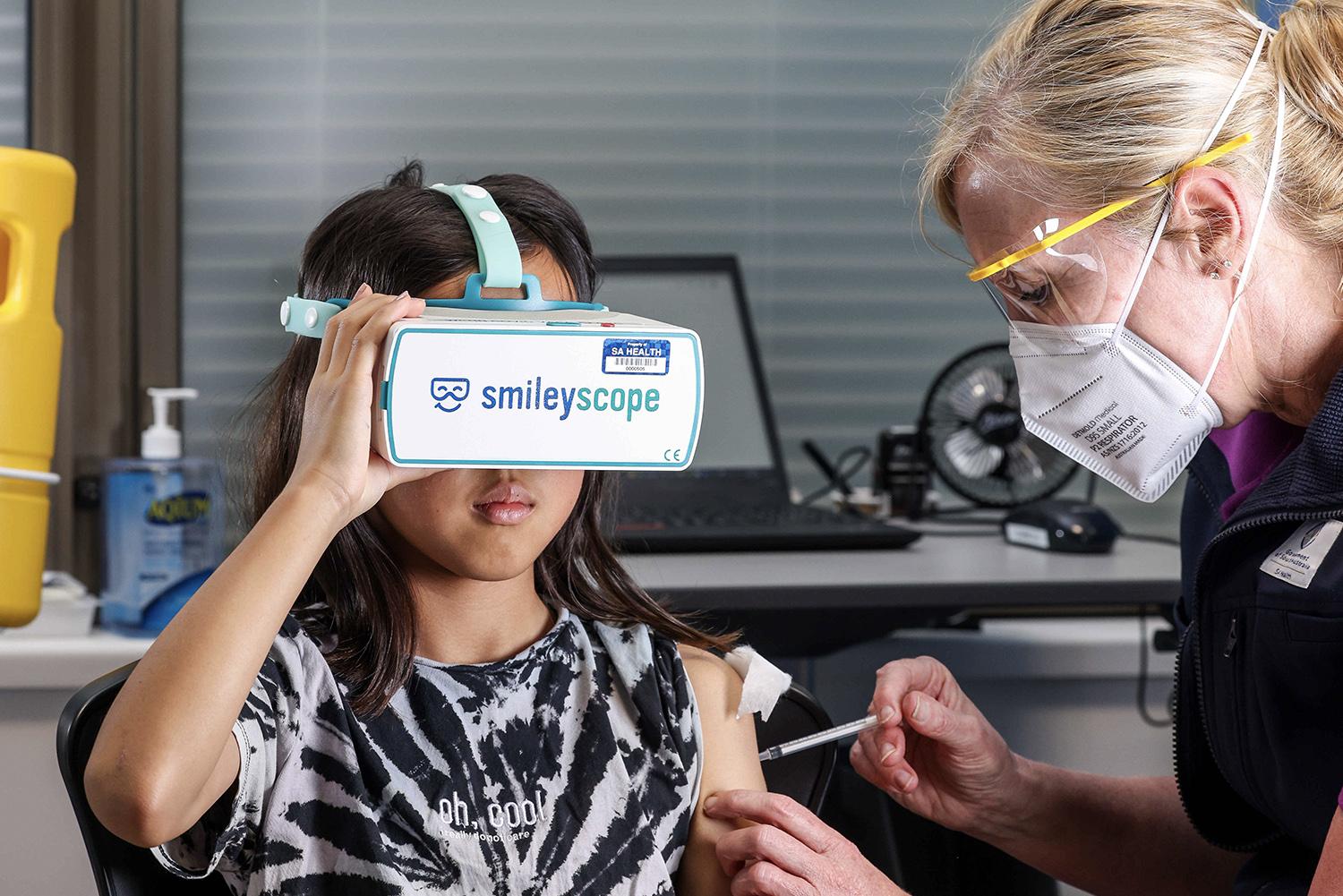Patient receiving vaccination using virtual reality headset