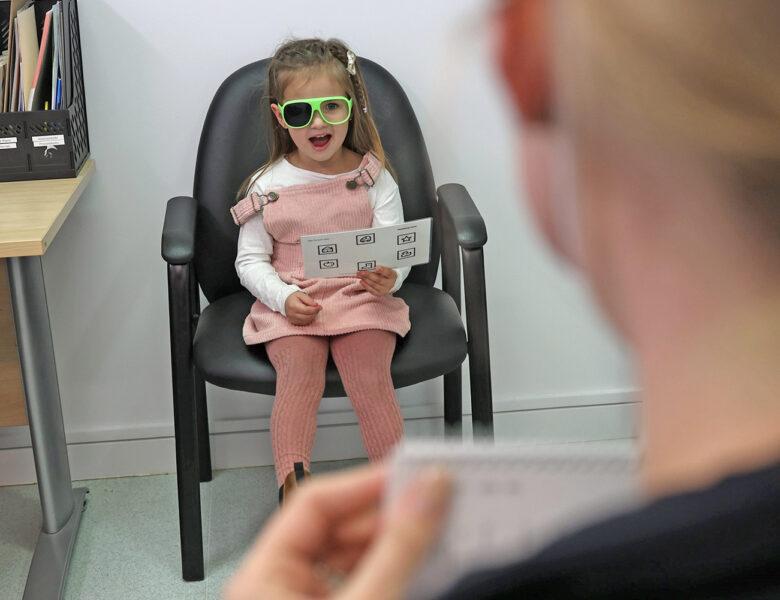 Young girl having her eyes tested.