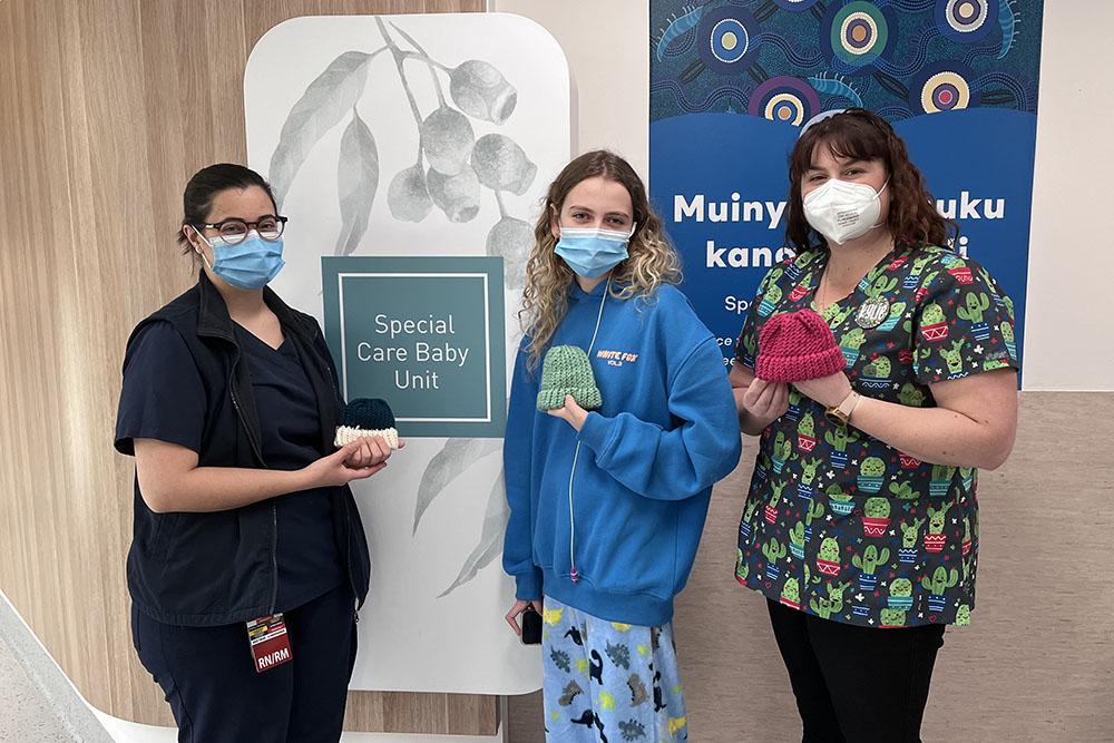 Adolescent Ward patient, Ashleigh, and Play Therapist, Kylie, meeting with SCBU nurse, Konnie, to donate these tiny beanies for premature babies. 