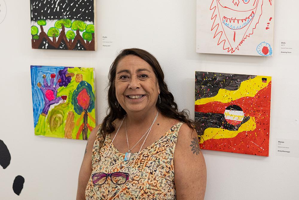 Amata Anangu School art teacher, Alejandra Catalan, with some of her student’s artworks. 